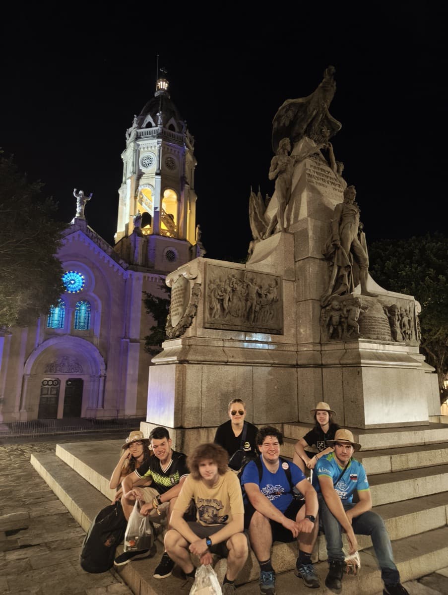 Ekipa na enem izmed trgov v mestnem jedru (oz. starem mestu) v Panama Cityju. Slika je bila zajeta na trgu Simón Bolívar, njemu je namenjena skulptura na sliki; v ozadju je vidna cerkev San Francisco de Asís  z barvnimi lučmi pri oknih in stolpu.